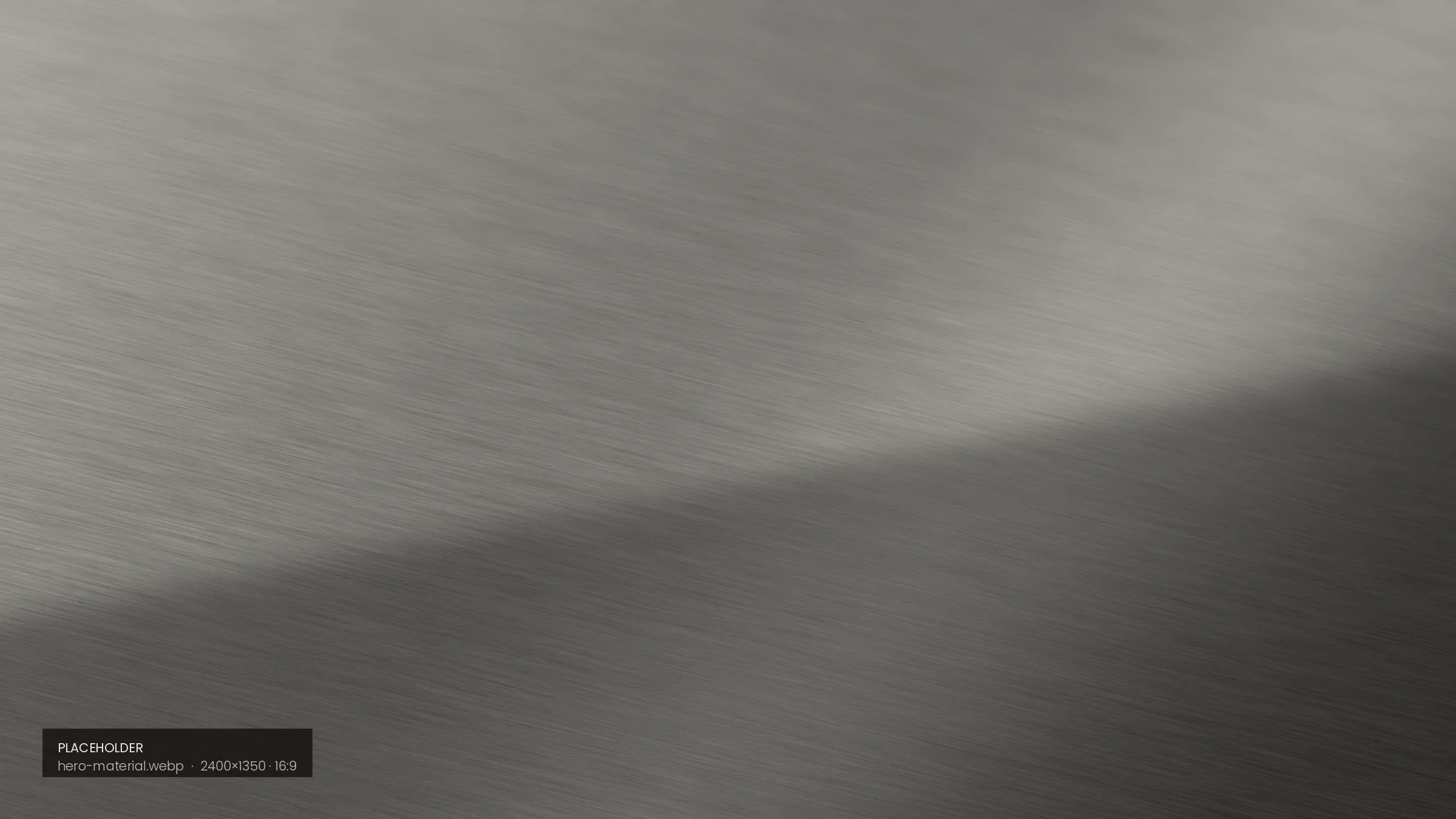 Macro study of a brushed metal surface crossed by a soft band of light